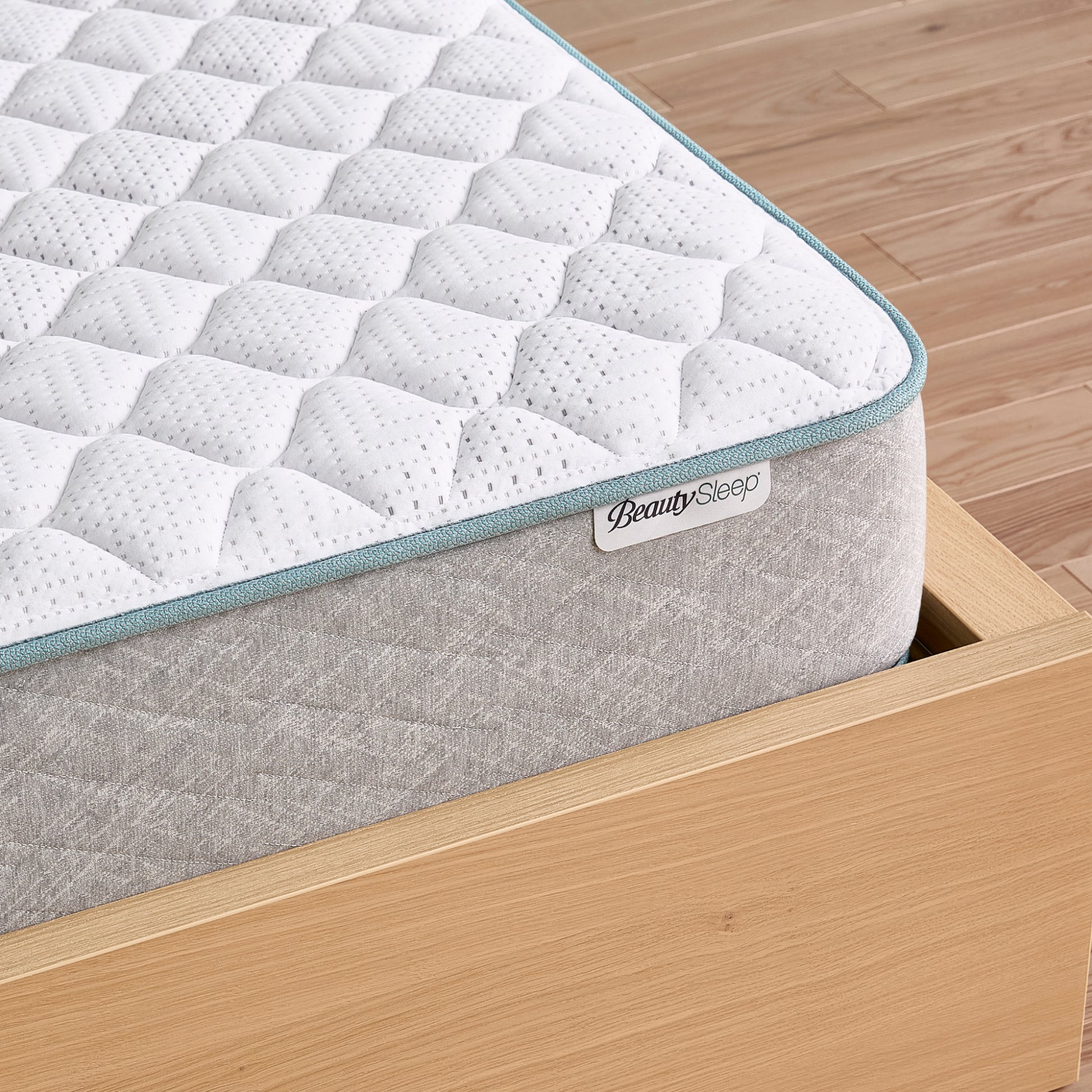 Beauty Sleep mattress with a textured surface on a wooden bed frame, featuring the BeautySleep brand.