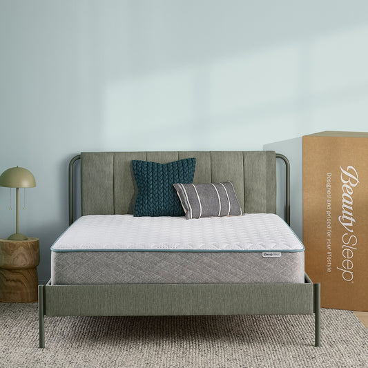 BeautySleep Mattress with green bed frame and pillows in a room setting, next to a 'Beauty Sleep' branded box.