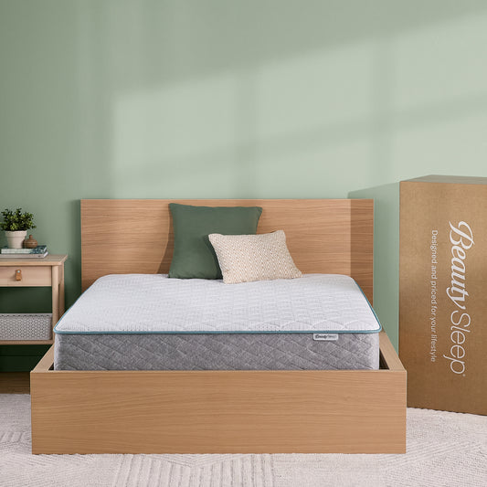 BeautySleep Mattress with Wooden bed frame and pillows in a room setting, next to a 'Beauty Sleep' branded box.