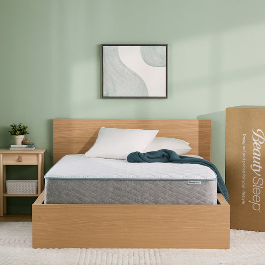 BeautySleep Mattress with wooden bed frame, mattress, and nightstand against a light green wall.
