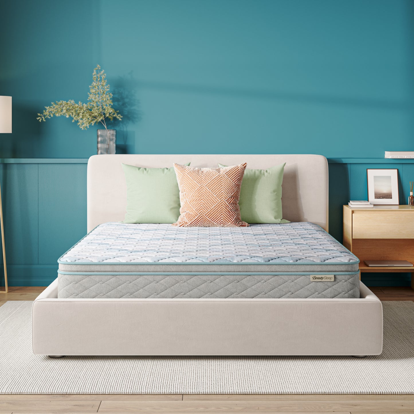 Beauty Sleep Mattress on a bed with decorative pillows against a blue wall