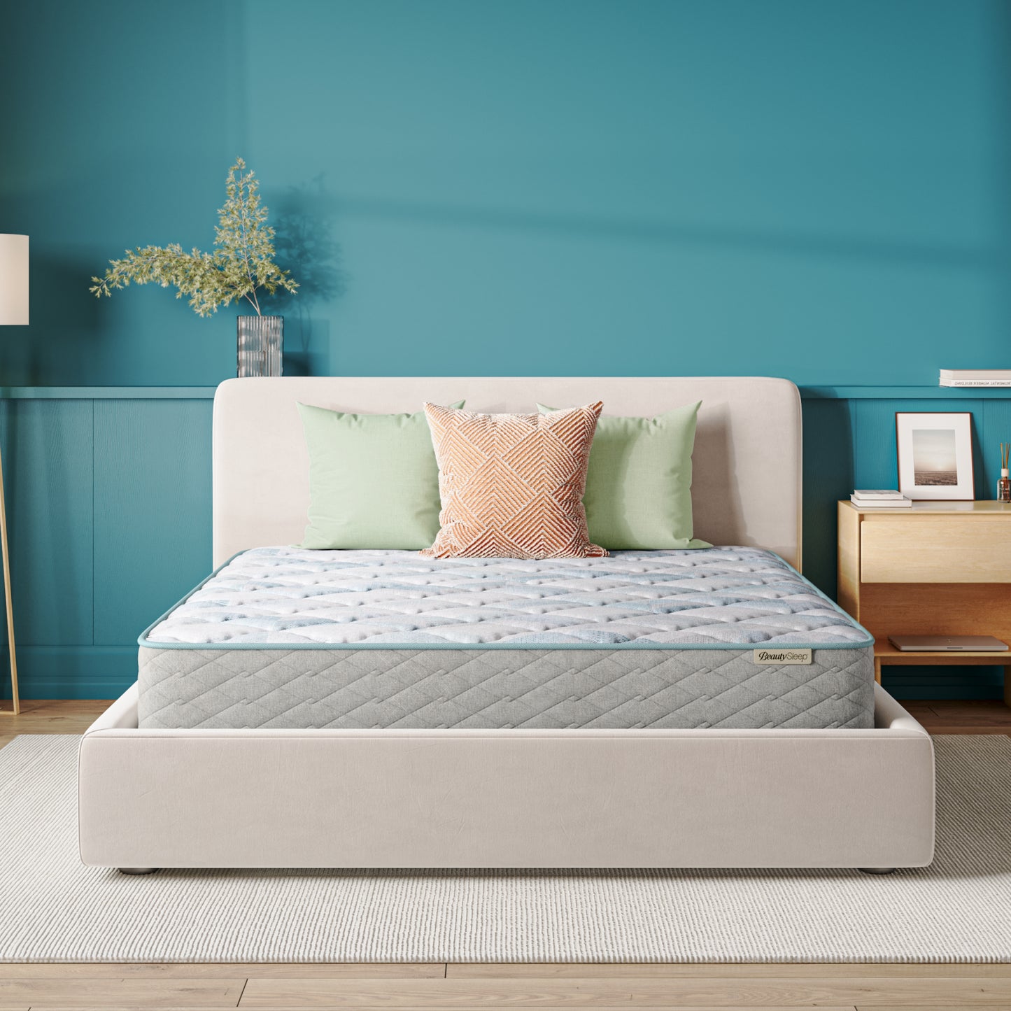 Beauty Sleep Mattress on a bed in a bedroom with teal walls and a nightstand.