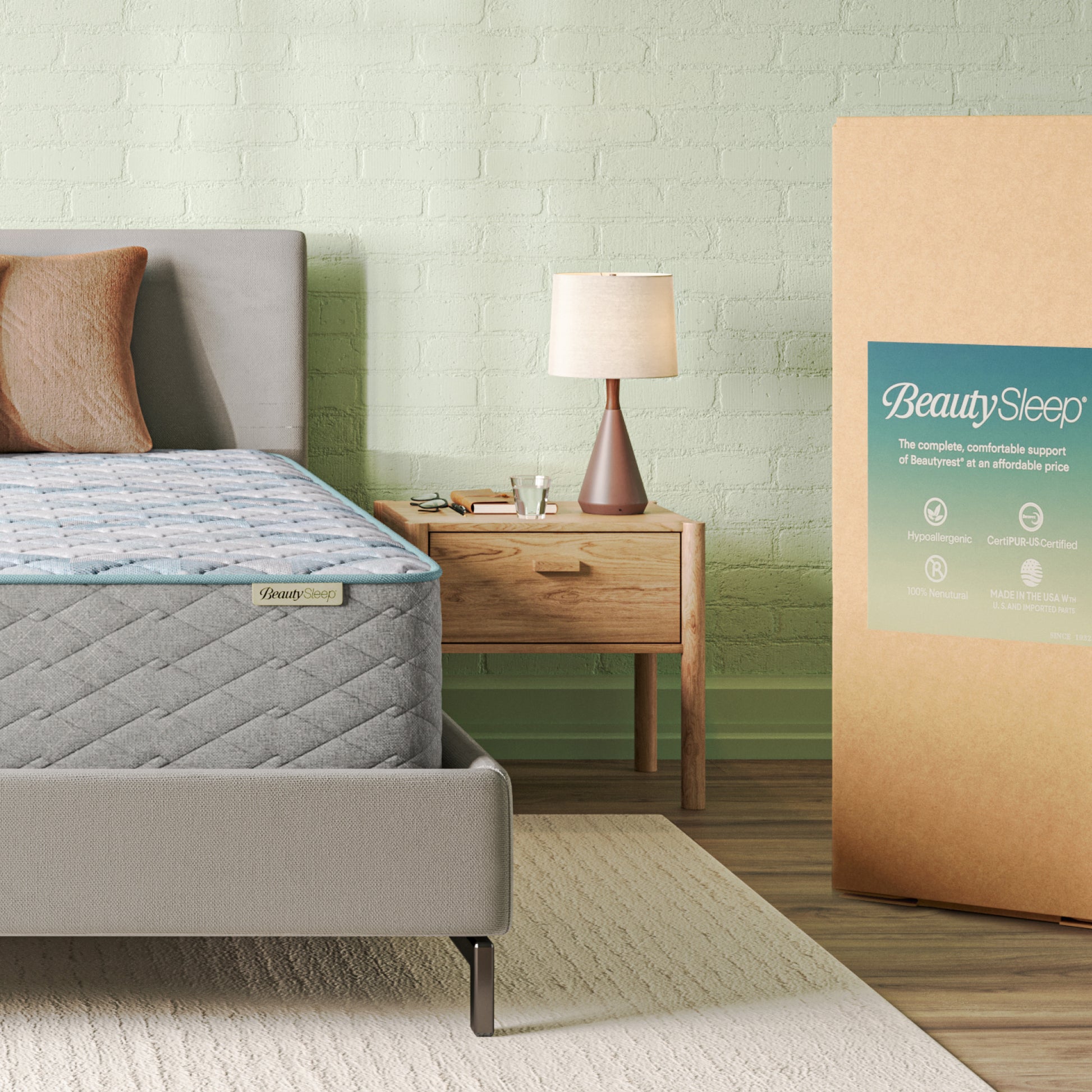 Bedroom with a mattress and BeautySleep packaging against a light brick wall.